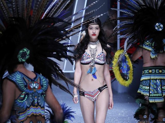 Artists perform as a model presents a creation by Aimer. (AP)