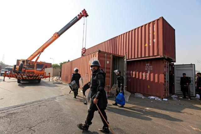 A Frontier Constabulary personnel walks past a shipping container being used to block roads ahead of a planned protest by Imran Khan’s Pakistan Tehreek-e-Insaf (PTI) party in Islamabad. (REUTERS) A Frontier Constabulary personnel walks past a shipping container being used to block roads ahead of a planned protest by Imran Khan’s Pakistan Tehreek-e-Insaf (PTI) party in Islamabad. (REUTERS)