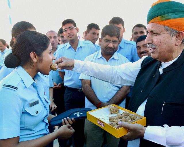 Minister of state for finance, Arjun Ram Meghwal offers sweet to air force jawans on Diwali in Bikaner on Sunday. (PTI Photo) Minister of state for finance, Arjun Ram Meghwal offers sweet to air force jawans on Diwali in Bikaner on Sunday. (PTI Photo)