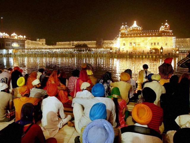 The Golden Temple, the holiest Sikh shrine, in Amritsar glittered with lights and traditional ‘diyas’. It witnessed a huge rush of devotees who took a dip in its holy tank and offered prayers at the sanctum sanctorum. (PTI) The Golden Temple, the holiest Sikh shrine, in Amritsar glittered with lights and traditional ‘diyas’. It witnessed a huge rush of devotees who took a dip in its holy tank and offered prayers at the sanctum sanctorum. (PTI)
