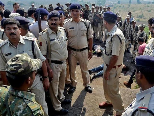 Policemen at the site where eight suspected SIMI members were killed in an encounter in Madhya Pradesh on Monday.(Reuters)