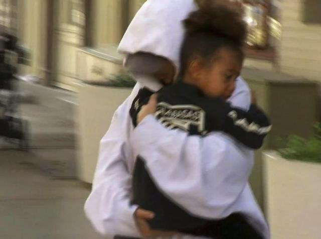 In this image made from video, Kim Kardashian West carries her daughter North West to an awaiting vehicle, Thursday, October 6, 2016, in New York. (AP) In this image made from video, Kim Kardashian West carries her daughter North West to an awaiting vehicle, Thursday, October 6, 2016, in New York. (AP)