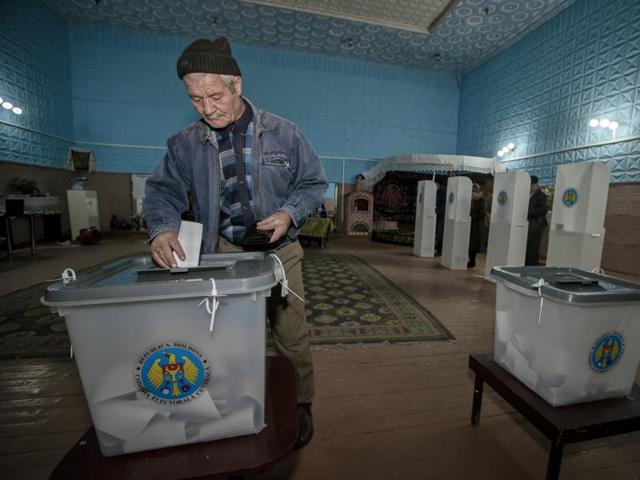 A man casts his ballot at a polling station during the presidential elections in the village of Boscana, Moldova on Sunday.(AP photo)