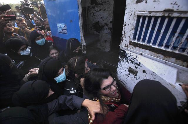 Women police officers detain supporters of cricketer-turned-politician Imran Khan near his residence on the outskirts of Islamabad on Monday. (AP) Women police officers detain supporters of cricketer-turned-politician Imran Khan near his residence on the outskirts of Islamabad on Monday. (AP)
