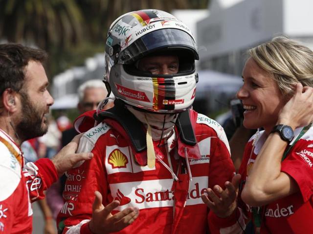 Ferrari team members confirm to Ferrari driver Sebastian Vettel, of Germany, that he has won third place during the Formula One Mexico Grand Prix. (AP Photo) Ferrari team members confirm to Ferrari driver Sebastian Vettel, of Germany, that he has won third place during the Formula One Mexico Grand Prix. (AP Photo)