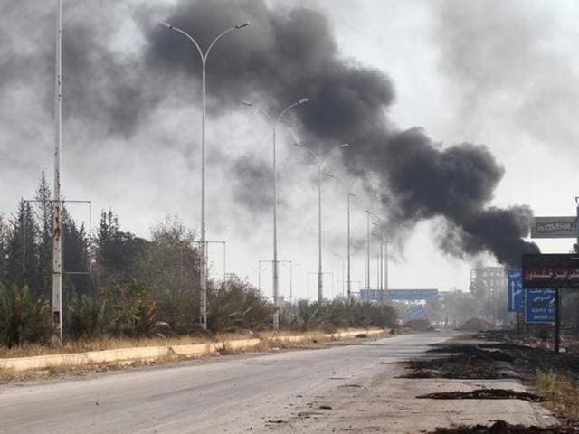 Smoke rises near a damaged road in Dahiyet al-Assad, west Aleppo city, Syria. (Reuters) Smoke rises near a damaged road in Dahiyet al-Assad, west Aleppo city, Syria. (Reuters)
