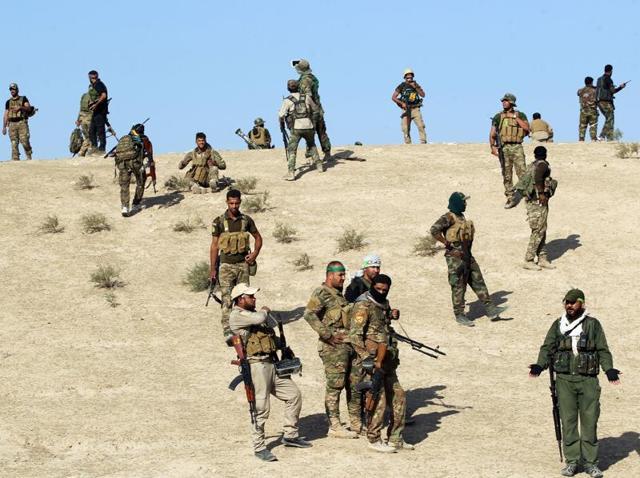 Shia fighters from the Hashed al-Shaabi advance towards the village of Salmani, south of Mosul, on during the ongoing battle against Islamic State group on Monday. (AFP) Shia fighters from the Hashed al-Shaabi advance towards the village of Salmani, south of Mosul, on during the ongoing battle against Islamic State group on Monday. (AFP)