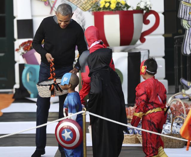 President Barack Obama hands treats. (AP Photo) 