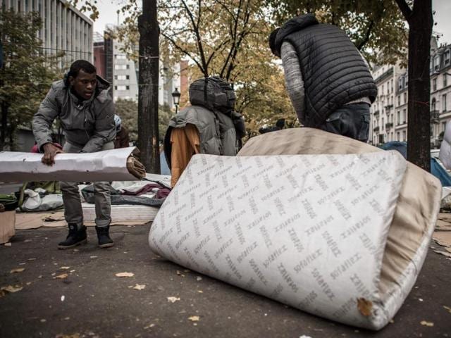 A placard reading "Need for refugees: Humanity" is seen next to a makeshift camp in Paris, on October 30, 2016 where migrants live in squalid conditions in one of the camps sprouting up around the French capital. (AFP pHOTO) A placard reading "Need for refugees: Humanity" is seen next to a makeshift camp in Paris, on October 30, 2016 where migrants live in squalid conditions in one of the camps sprouting up around the French capital. (AFP pHOTO)