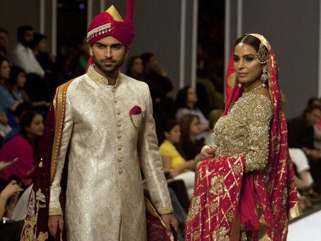 Models present creations by designer Deepak Parwani during the Fashion Pakistan Week Winter Festive 16, in Karachi, Pakistan on Monday. (AP) Models present creations by designer Deepak Parwani during the Fashion Pakistan Week Winter Festive 16, in Karachi, Pakistan on Monday. (AP)