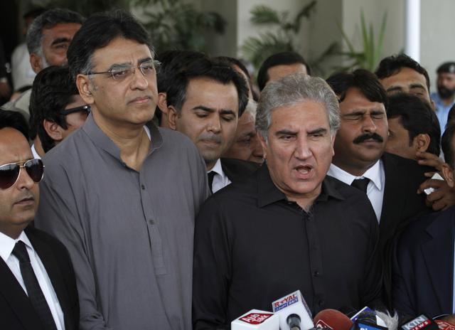 Pakistan Tehreek-e-Insaf leaders Shah Mahmood Qureshi is surrounded by lawyers and his party colleagues as he speaks to journalists outside the Supreme Court in Islamabad on Tuesday. (AP) Pakistan Tehreek-e-Insaf leaders Shah Mahmood Qureshi is surrounded by lawyers and his party colleagues as he speaks to journalists outside the Supreme Court in Islamabad on Tuesday. (AP)
