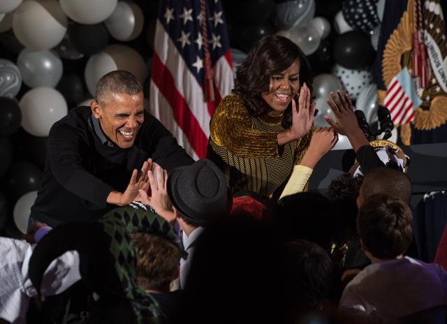 US President Barack Obama and Michelle Obama high-five children on Halloween. (AFP Photo) 