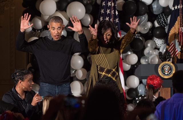 US President Barack Obama and First Lady Michelle Obama dance along with children performing Michael Jackson'n Thriller in the East Room at the White House during a Halloween event in Washington, DC. (AFP Photo) 