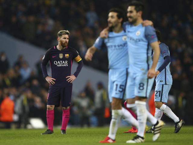 Barcelona's Lionel Messi, left, looks disappointed as Manchester City players celebrate after the end of their Champions League group C match at the Etihad stadium in Manchester, on November 1, 2016. Manchester City won 3-1. (AP) 