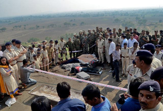 Bhopal: Police investigate the encounter site at the hillocks of Acharpura village after the STF killed 8 Students of Islamic Movement of India (SIMI) activists who escaped Central Jail killing a security guard in Bhopal on Monday.(PTI)