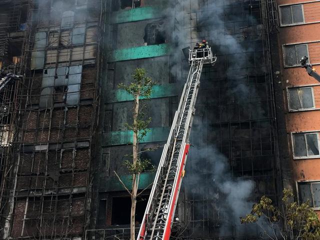 Firefighters work after a fire broke out at a karaoke lounge in Hanoi, Vietnam on Tuesday. (Reuters) Firefighters work after a fire broke out at a karaoke lounge in Hanoi, Vietnam on Tuesday. (Reuters)