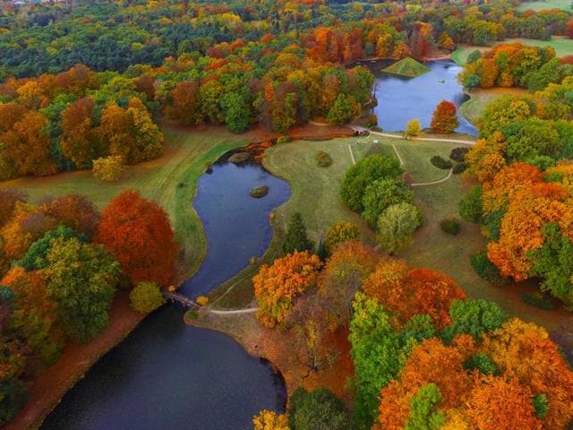 An aerial view taken with a drone shows the autumnally colored Fuerst-Pueckler-Park near Cottbus, eastern Germany. The park, built in the 19th century by Prince Hermann von Pueckler-Muskau, is considered as one of the last great German landscape gardens. (Patrick Pleul/dpa via AP)