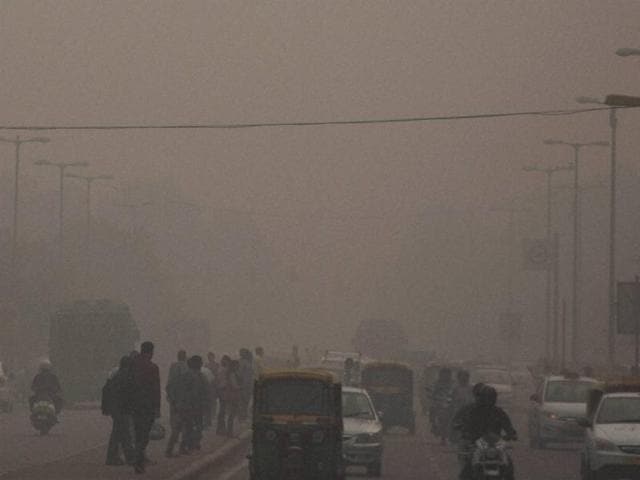 Commuters in New Delhi, which is covered with dense smog as pollution hits hazardous levels on Wednesday. (PTI) Commuters in New Delhi, which is covered with dense smog as pollution hits hazardous levels on Wednesday. (PTI)