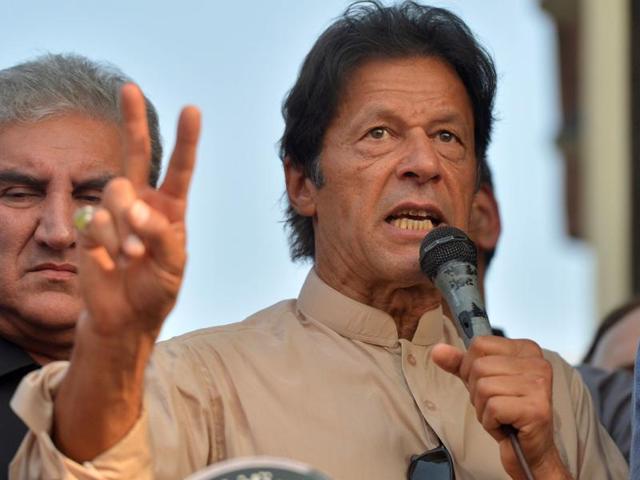 Pakistan Tehreek-i-Insaf activists gesture as they listen to their leader Imran Khan address them outside his residence in Islamabad on Tuesday. (AFP) Pakistan Tehreek-i-Insaf activists gesture as they listen to their leader Imran Khan address them outside his residence in Islamabad on Tuesday. (AFP)