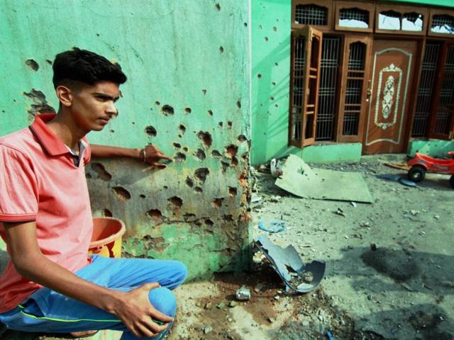 A villager showing the wall of a building damaged by alleged shelling from the Pakistani side at Rangoor camp in Ramgarh sector. (PTI) A villager showing the wall of a building damaged by alleged shelling from the Pakistani side at Rangoor camp in Ramgarh sector. (PTI)