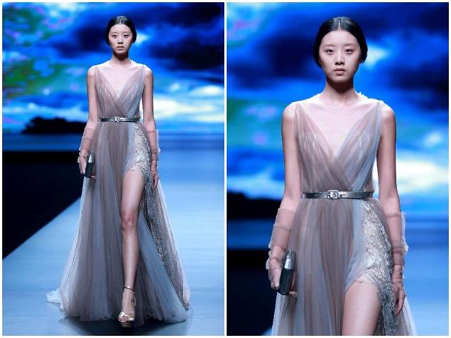 A model parades a creation from AM.IXAM Collection. (AFP) A model parades a creation from AM.IXAM Collection. (AFP)