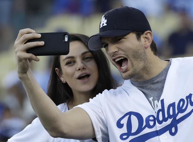 Ashton Kutcher and wife Mila Kunis take a selfie before Game 4 of the National League baseball championship series between the Chicago Cubs and the Los Angeles Dodgers on Wednesday, October 9. (AP)