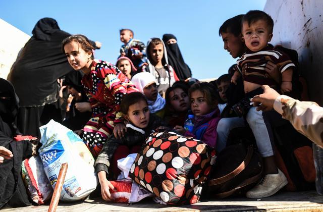 Iraqi families, who fled the violence due to the ongoing operation by Iraqi forces against jihadists of the Islamic State group to retake the city of Mosul, board a truck before heading to camps housing displaced people on November 3, 2016 near Gogjali, which lies on the eastern edge of Mosul. (AFP) Iraqi families, who fled the violence due to the ongoing operation by Iraqi forces against jihadists of the Islamic State group to retake the city of Mosul, board a truck before heading to camps housing displaced people on November 3, 2016 near Gogjali, which lies on the eastern edge of Mosul. (AFP)