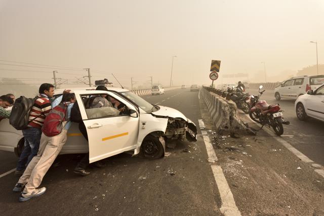 People assist in removing an accident damaged taxi on the NH8 in New Delhi, India, on Thursday, November 3, 2016. Insufficiently marked dividers (road bifurcates) are cause for several accidents on the fast moving expressway. (Gurinder Osan/HT PHOTO) People assist in removing an accident damaged taxi on the NH8 in New Delhi, India, on Thursday, November 3, 2016. Insufficiently marked dividers (road bifurcates) are cause for several accidents on the fast moving expressway. (Gurinder Osan/HT PHOTO)