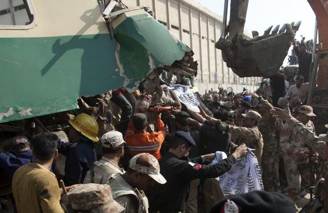 People remove an injured passenger from a wreckage of a train which collided with another train in Karachi, Pakistan. (AP) People remove an injured passenger from a wreckage of a train which collided with another train in Karachi, Pakistan. (AP)