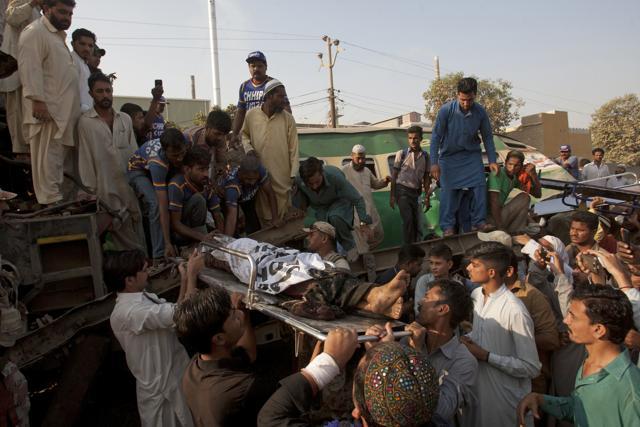 Pakistani volunteers remove an injured passenger from a train that collided with another train in Karachi, Pakistan. (AP) Pakistani volunteers remove an injured passenger from a train that collided with another train in Karachi, Pakistan. (AP)
