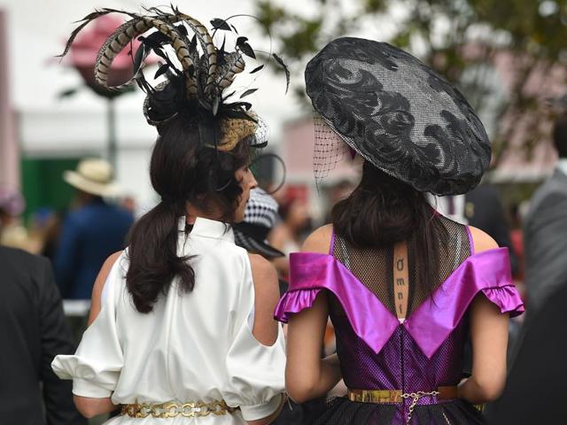 Racegoers in fancy hats take part in the festivities. (AFP) Racegoers in fancy hats take part in the festivities. (AFP)
