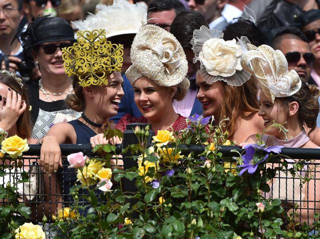 Girls like hats, no matter what the design. Racegoers react during the event. (AFP) Girls like hats, no matter what the design. Racegoers react during the event. (AFP)