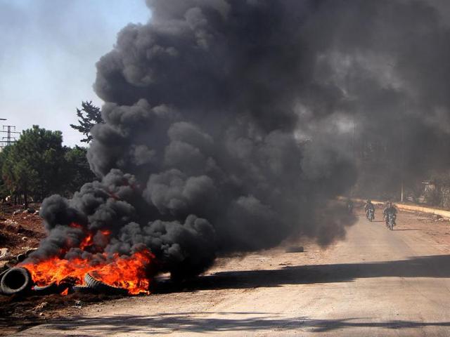 Rebel fighters from the Jaish al-Fatah (or Army of Conquest) brigades drive past burning tyres on November 3, 2016, at an entrance to Aleppo, in the southwestern frontline near the neighbourhood of Dahiyet al-Assad, during a rebel offensive to break a three-month siege of the opposition-held east of Syria's second city. (AFP) Rebel fighters from the Jaish al-Fatah (or Army of Conquest) brigades drive past burning tyres on November 3, 2016, at an entrance to Aleppo, in the southwestern frontline near the neighbourhood of Dahiyet al-Assad, during a rebel offensive to break a three-month siege of the opposition-held east of Syria's second city. (AFP)