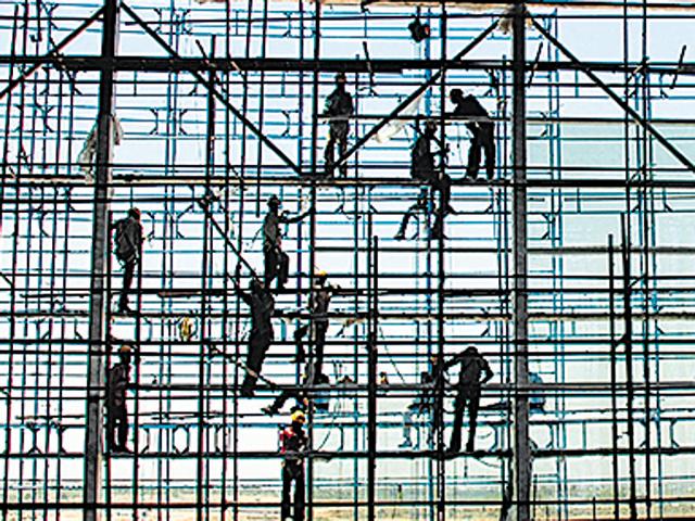 Workers place glass sheets at the new terminal building in GMR Hyderabad International Airport (GHIAL) at Hyderabad. (AFP) Workers place glass sheets at the new terminal building in GMR Hyderabad International Airport (GHIAL) at Hyderabad. (AFP)
