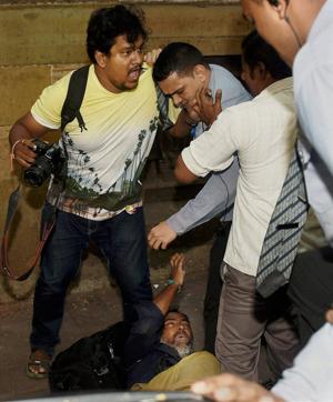 Private security personnel of Tata Group assault photojournalists who had assembled at Bombay House for the Indian Hotels’ board meeting in Mumbai on Friday. (PTI) Private security personnel of Tata Group assault photojournalists who had assembled at Bombay House for the Indian Hotels’ board meeting in Mumbai on Friday. (PTI)