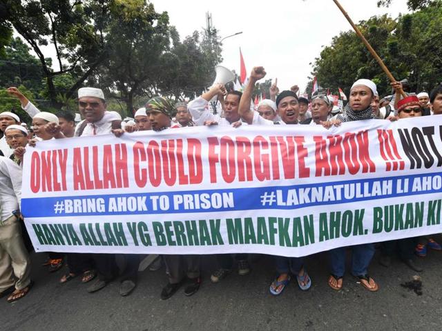 Muslim protesters gather with a banner calling for the arrest of Jakarta's ethnic Chinese and Christian Governor Basuki Tjahaja Purnama on blasphemy. (AP Photo) Muslim protesters gather with a banner calling for the arrest of Jakarta's ethnic Chinese and Christian Governor Basuki Tjahaja Purnama on blasphemy. (AP Photo)