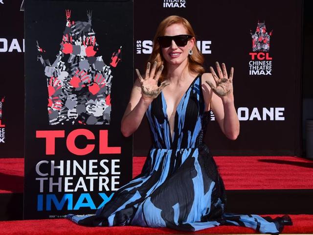 The gorgeous redhead donned a bold printed navy and light blue plunging dress. (AFP) The gorgeous redhead donned a bold printed navy and light blue plunging dress. (AFP)
