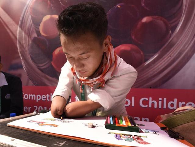 A physically challenged school student Logsang Chongey participates in a painting competition during the 3-day Asian Ministerial Conference for Disaster Risk Reduction (AMCDRR) 2016 in Delhi. (Sonu Mehta/HT PHOTO) A physically challenged school student Logsang Chongey participates in a painting competition during the 3-day Asian Ministerial Conference for Disaster Risk Reduction (AMCDRR) 2016 in Delhi. (Sonu Mehta/HT PHOTO)