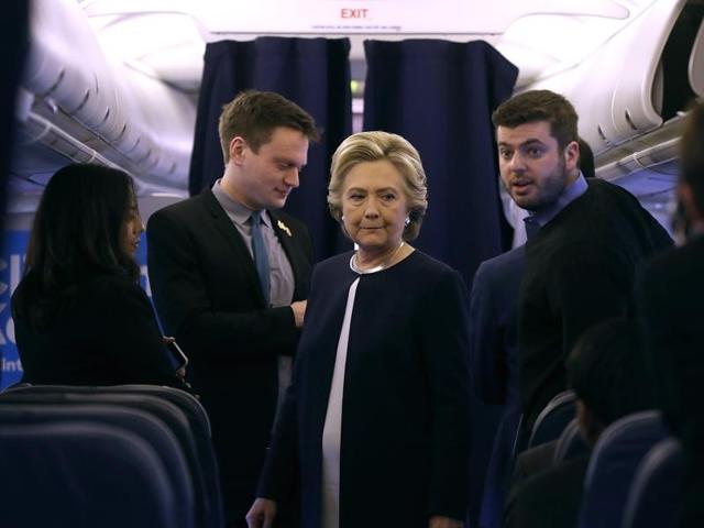 Democratic presidential nominee former Secretary of State Hillary Clinton talks with members of her staff aboard her campaign plane at Westchester County Airport on November 4, 2016 in White Plains, New York. (AFP) Democratic presidential nominee former Secretary of State Hillary Clinton talks with members of her staff aboard her campaign plane at Westchester County Airport on November 4, 2016 in White Plains, New York. (AFP)