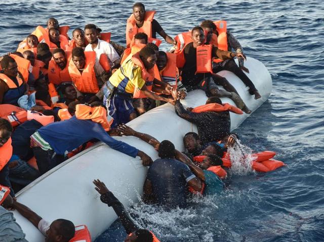 Migrants and refugees panic as they fall in the water during a rescue operation called the Topaz Responder. The mission is a rescue ship run by the Maltese NGO Moas and Italian Red Cross, off the Libyan coast in the Mediterranean Sea, on November 3, 2016. (ANDREAS SOLARO/AFP photo) Migrants and refugees panic as they fall in the water during a rescue operation called the Topaz Responder. The mission is a rescue ship run by the Maltese NGO Moas and Italian Red Cross, off the Libyan coast in the Mediterranean Sea, on November 3, 2016. (ANDREAS SOLARO/AFP photo)