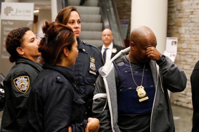 New York Police officers arrive at the Jacobi Medical Center after a police officer was fatally shot and another wounded.  (Reuters Photo)
