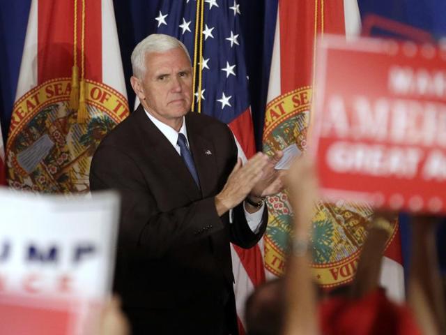 Republican vice presidential candidate Indiana Governor Mike Pence acknowledges supporters as they chant pro Trump slogans at the campaign rally. (AP) Republican vice presidential candidate Indiana Governor Mike Pence acknowledges supporters as they chant pro Trump slogans at the campaign rally. (AP)