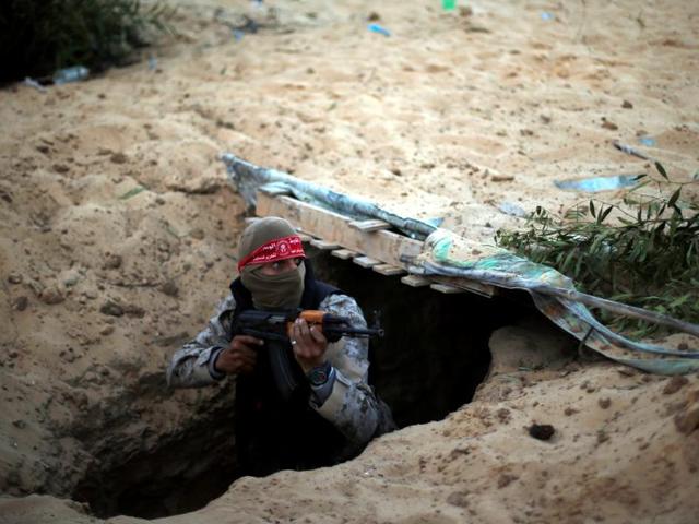 A Palestinian member of the Democratic Front for the Liberation of Palestine (DFLP) gets out of a tunnel during a graduation ceremony in Rafah in the southern Gaza Strip on November 4, 2016. (Suhaib Salem/reuters) A Palestinian member of the Democratic Front for the Liberation of Palestine (DFLP) gets out of a tunnel during a graduation ceremony in Rafah in the southern Gaza Strip on November 4, 2016. (Suhaib Salem/reuters)