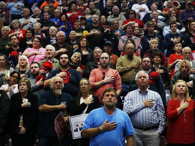 Donald Trump supporters wait for him to speak at a rally on November 4, 2016 in Hershey, Pennsylvania. Days before the presidential election, both Hillary Clinton and Donald Trump make their final pitches to the American people, with recent polls show a tightening race in crucial swing states.  (AFP) 