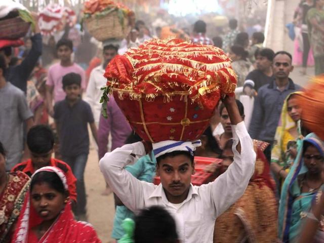 Devotees carrying sweets and fruits in decorated baskets to perform Chhath puja in Patiala on Sunday. (Bharat Bhushan/HT Photo)