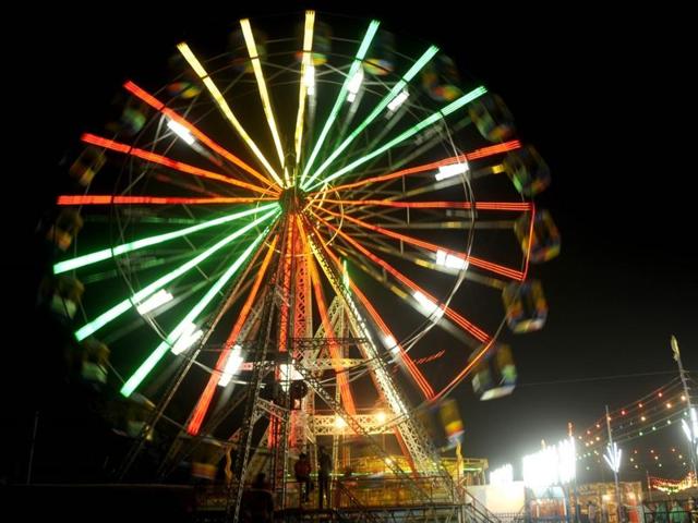 People enjoying swings during the Chhath puja celebrations in Patiala on Sunday. (Bharat Bhushan/HT Photo)