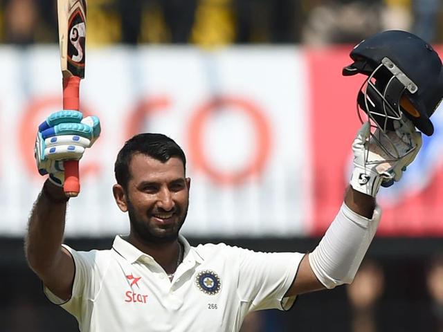 Cheteshwar Pujara raises his bat after completing his half-century against New Zealand. (PTI Photo) Cheteshwar Pujara raises his bat after completing his half-century against New Zealand. (PTI Photo)