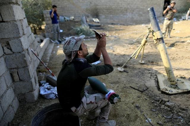 A soldier takes a selfie as rocket lies on his thigh during fighting with Islamic States militants, in the Shahrazad disrict of eastern Mosul, Iraq. (REUTERS) A soldier takes a selfie as rocket lies on his thigh during fighting with Islamic States militants, in the Shahrazad disrict of eastern Mosul, Iraq. (REUTERS)