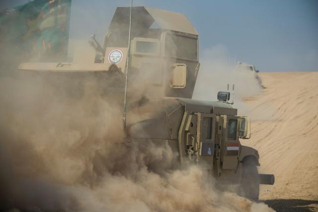 A convoy of the Iraqi army's 9th armoured division drives through an open field to approach the eastern Al-Intissar neighbourhood of Mosul on November 6, 2016, during a military operation to retake the main hub city from the Islamic State (IS) group jihadists. (AFP) A convoy of the Iraqi army's 9th armoured division drives through an open field to approach the eastern Al-Intissar neighbourhood of Mosul on November 6, 2016, during a military operation to retake the main hub city from the Islamic State (IS) group jihadists. (AFP)