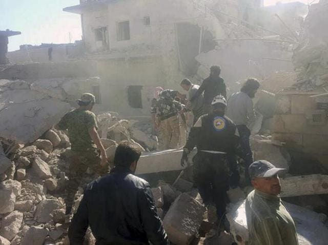This photo provided by the Syrian Civil Defense White Helmets, which has been authenticated based on its contents and other AP reporting, shows Civil Defense workers and Syrian citizens inspecting damaged buildings after airstrikes hit in Darat Izza town, in rural western Aleppo province, Syria. (AP) This photo provided by the Syrian Civil Defense White Helmets, which has been authenticated based on its contents and other AP reporting, shows Civil Defense workers and Syrian citizens inspecting damaged buildings after airstrikes hit in Darat Izza town, in rural western Aleppo province, Syria. (AP)